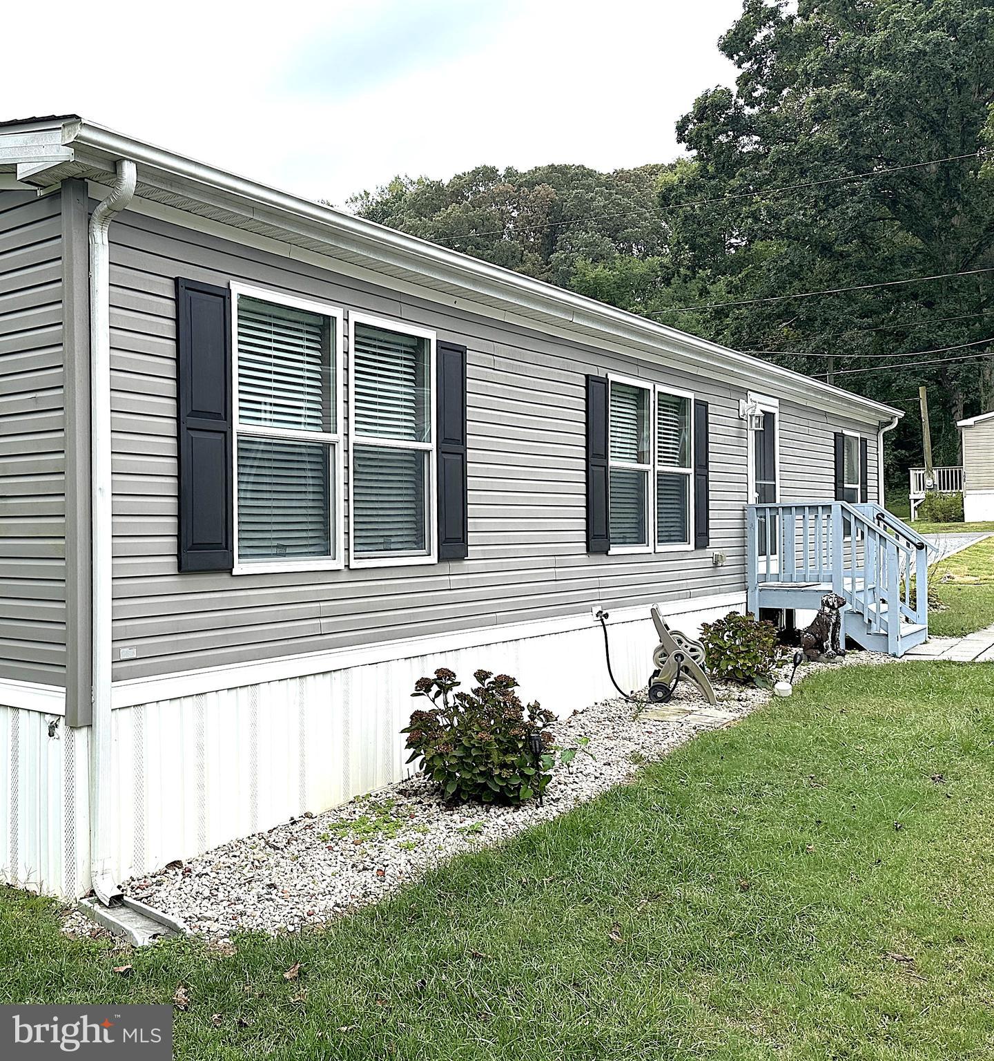 1277 Ritchie Highway, Unit 195 Arnold, MD 21012 - Photo 27 of 30 a house with trees in front of it