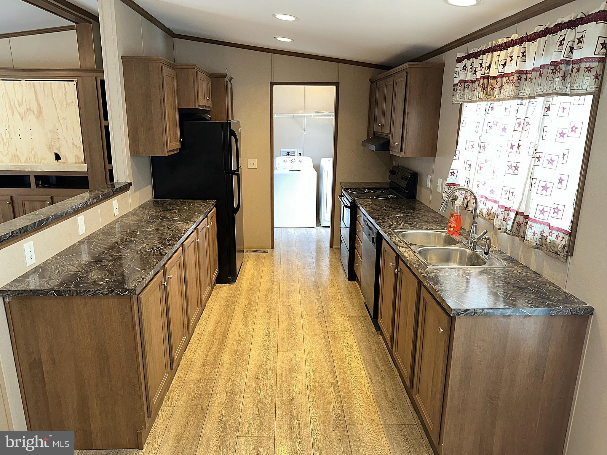 1277 Ritchie Highway, Unit 195 Arnold, MD 21012 - Photo 3 of 30 a kitchen with stainless steel appliances granite countertop a stove a sink and a refrigerator