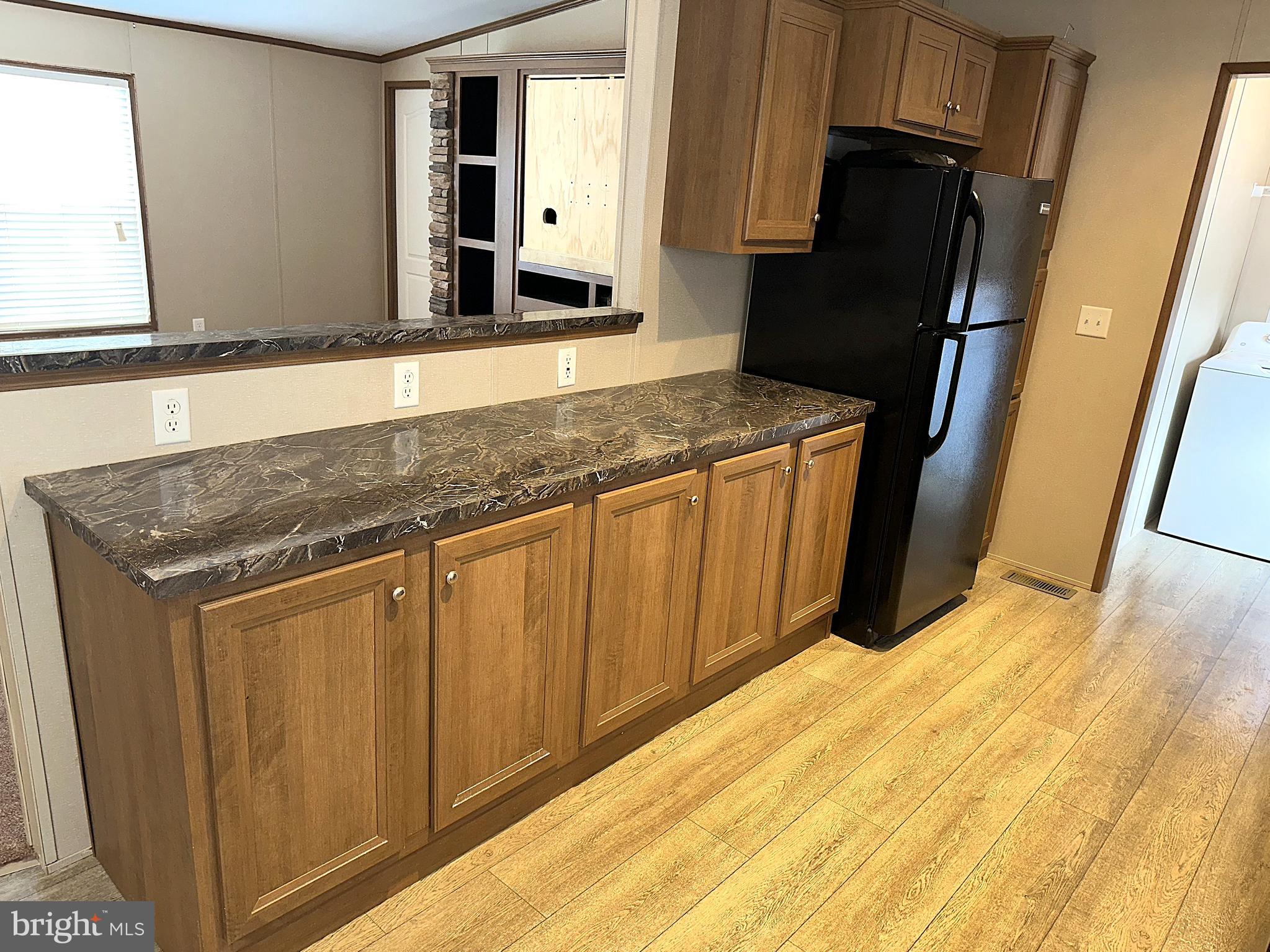 1277 Ritchie Highway, Unit 195 Arnold, MD 21012 - Photo 4 of 30 a kitchen with stainless steel appliances granite countertop a refrigerator and a sink