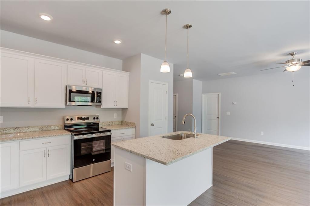 771 Dortch Road Eastanollee, GA 30538 - Photo 16 of 38 a kitchen with stainless steel appliances granite countertop a sink stove and refrigerator