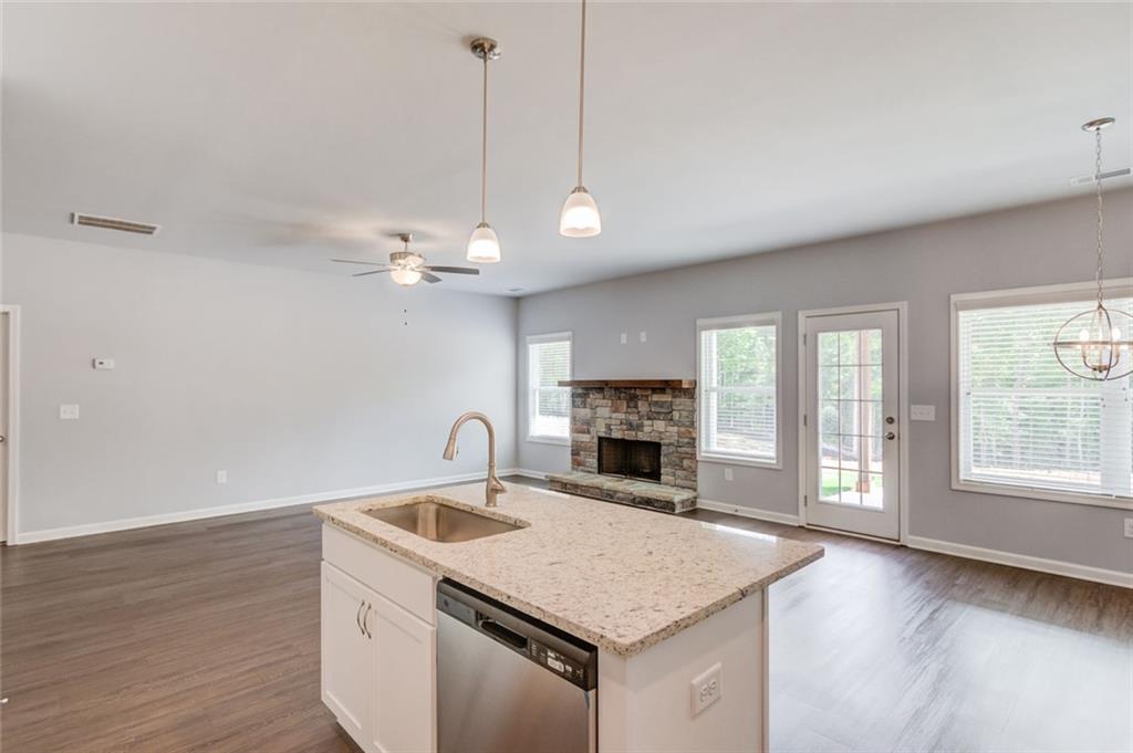 771 Dortch Road Eastanollee, GA 30538 - Photo 17 of 38 a kitchen with a stove a sink a chandelier and wooden floor