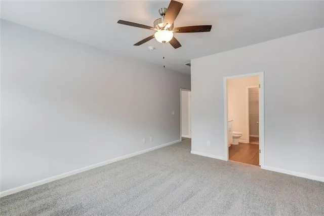 an empty room with chandelier fan