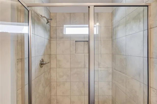 a bathroom with a glass shower door