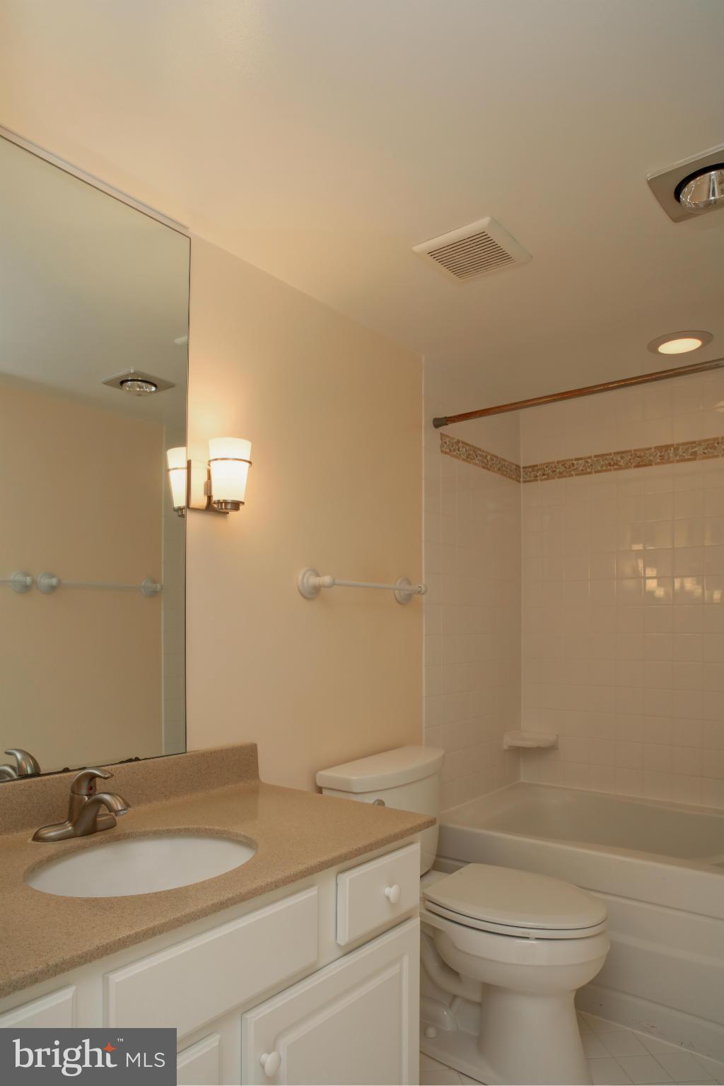 1800 Old Meadow Road, Unit 713 McLean, VA 22102 - Photo 16 of 27 a bathroom with a granite countertop sink toilet and shower