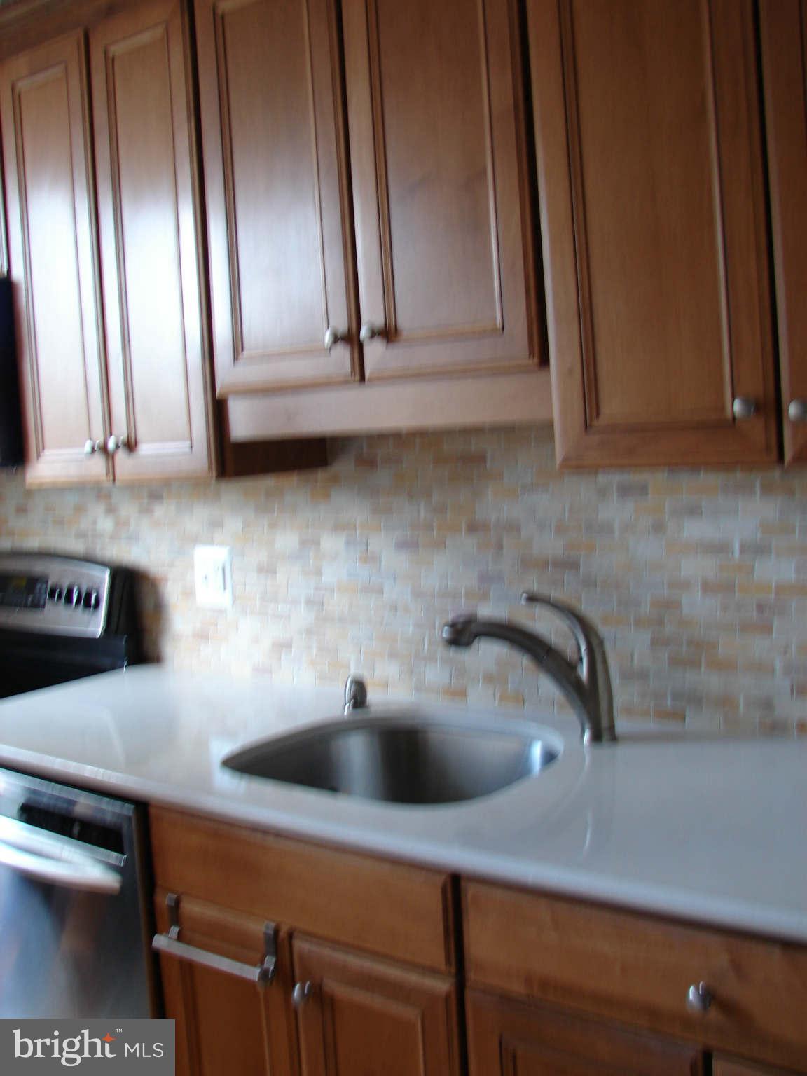 1800 Old Meadow Road, Unit 713 McLean, VA 22102 - Photo 3 of 27 a kitchen with a sink and cabinets