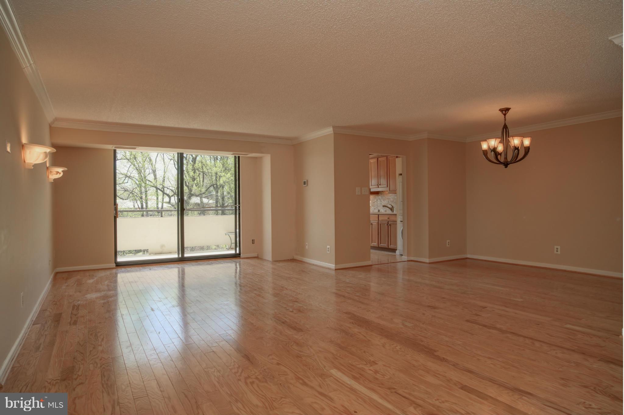 1800 Old Meadow Road, Unit 713 McLean, VA 22102 - Photo 22 of 27 a view of an empty room with a window and wooden floor