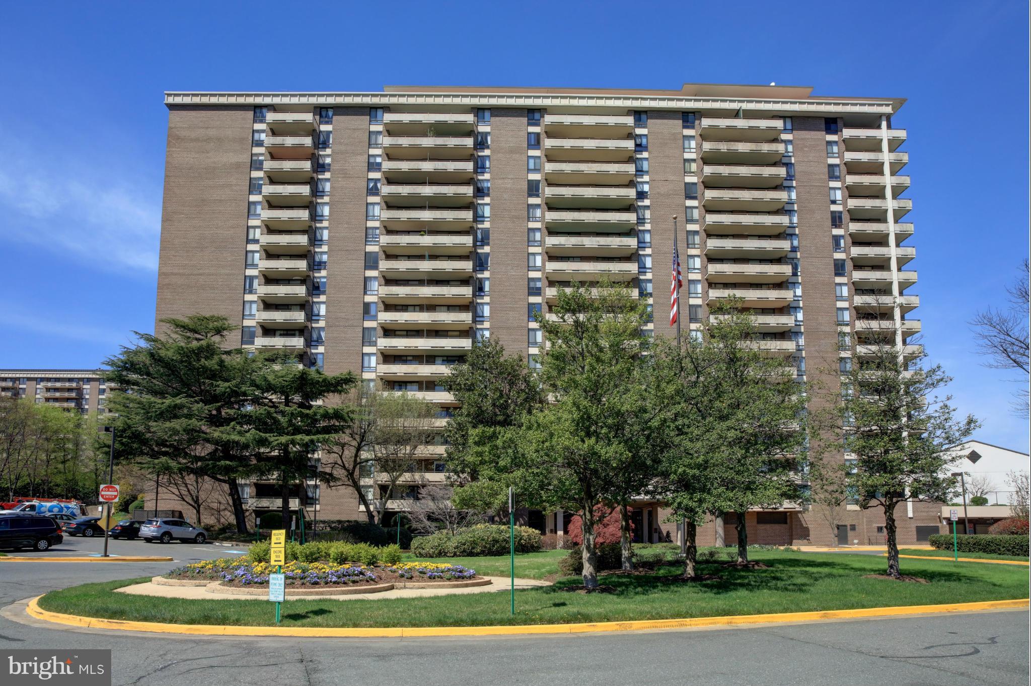 1800 Old Meadow Road, Unit 713 McLean, VA 22102 - Photo 23 of 27 a view of a tall building with a yard and plants