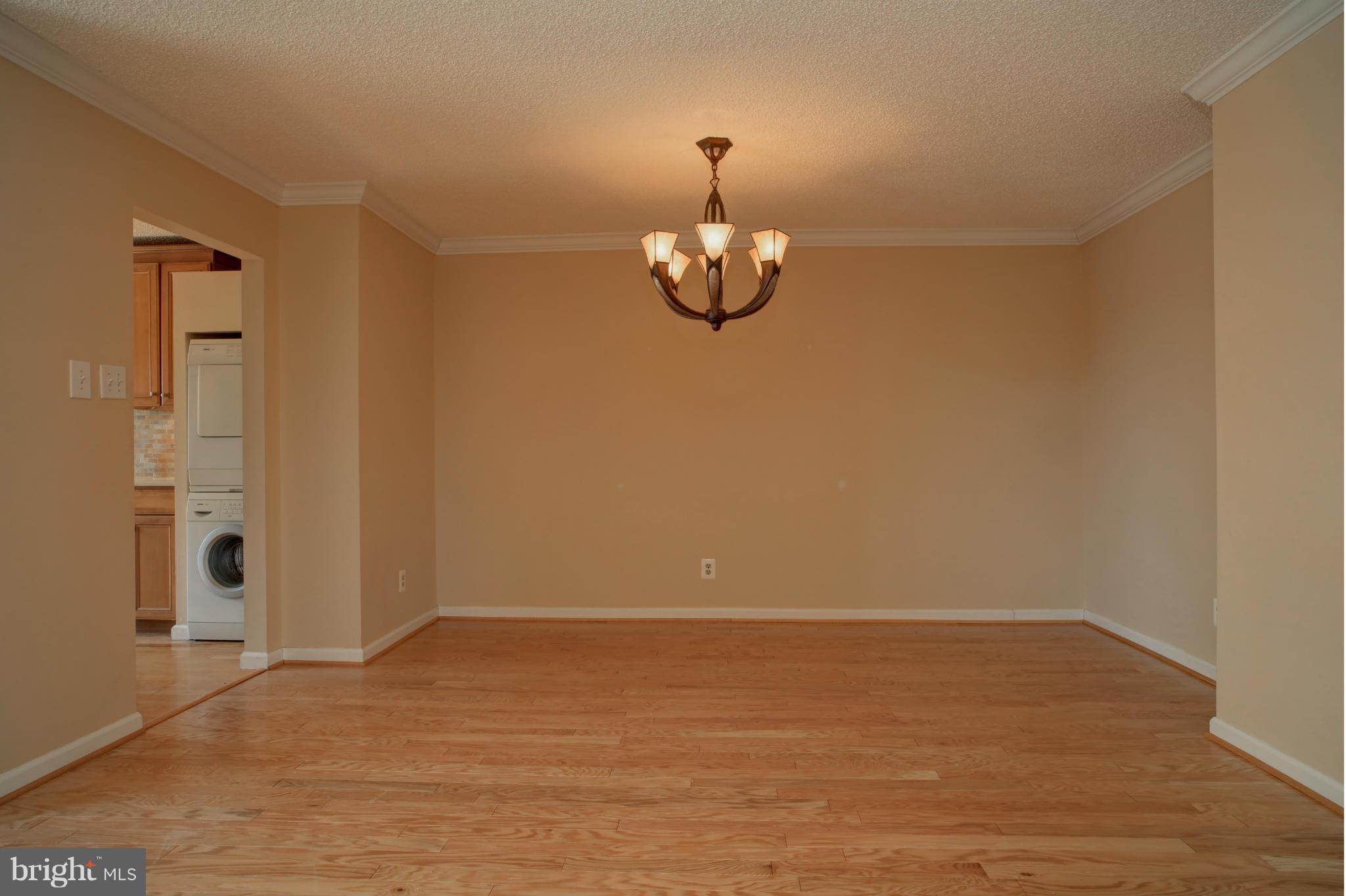 1800 Old Meadow Road, Unit 713 McLean, VA 22102 - Photo 7 of 27 a view of a room with wooden floor and ceiling fan