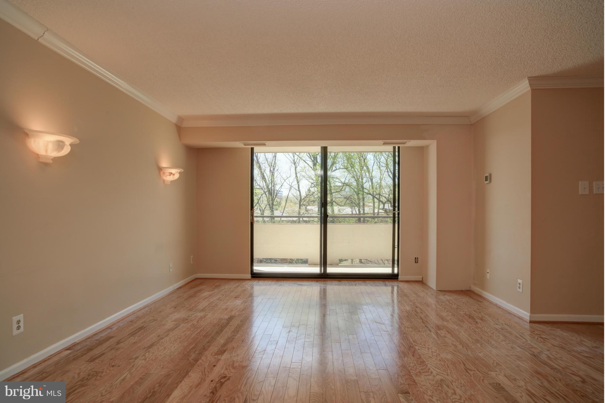 1800 Old Meadow Road, Unit 713 McLean, VA 22102 - Photo 8 of 27 a view of an empty room with wooden floor and a window