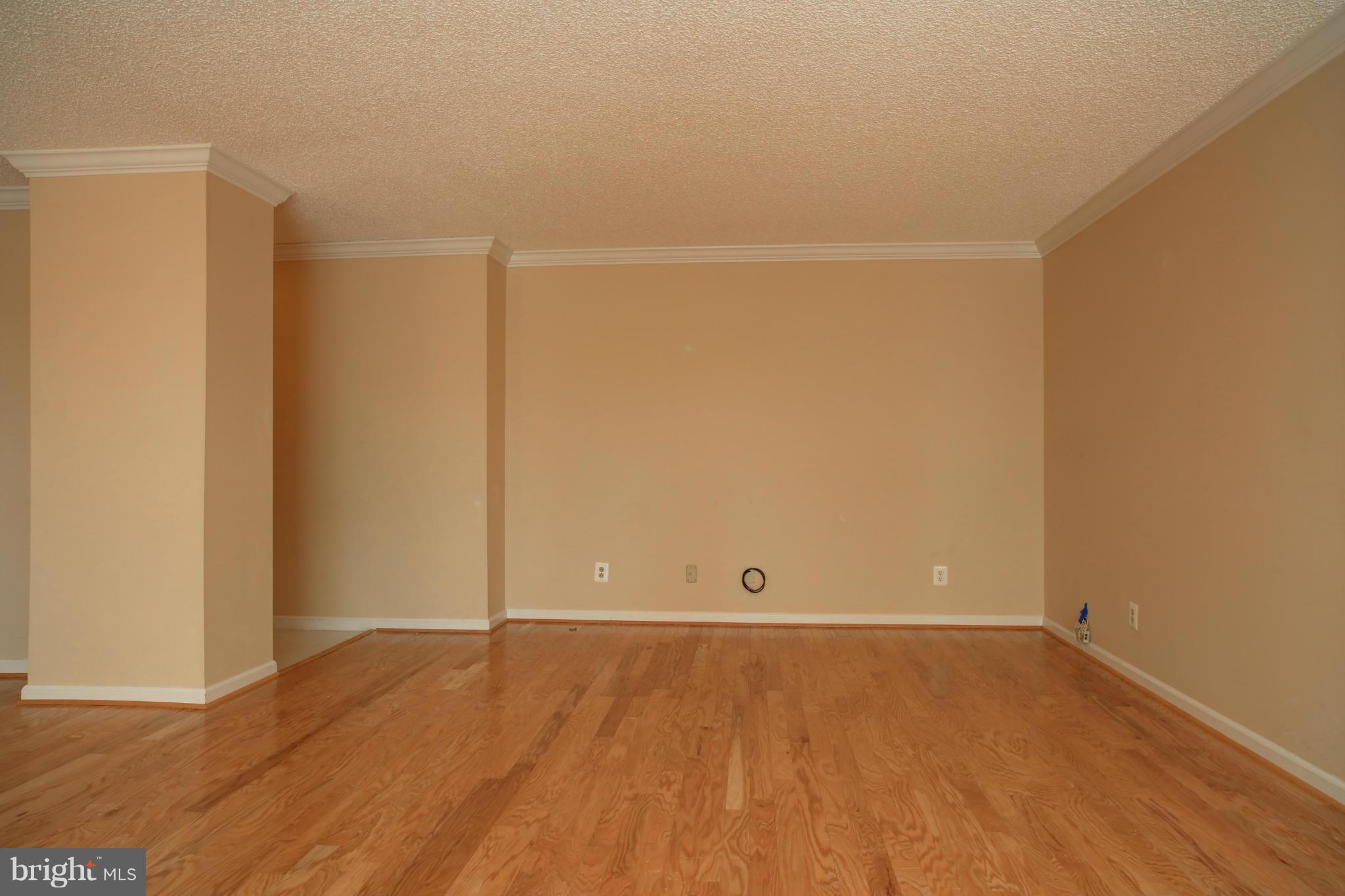 1800 Old Meadow Road, Unit 713 McLean, VA 22102 - Photo 9 of 27 an empty room with wooden floor and windows