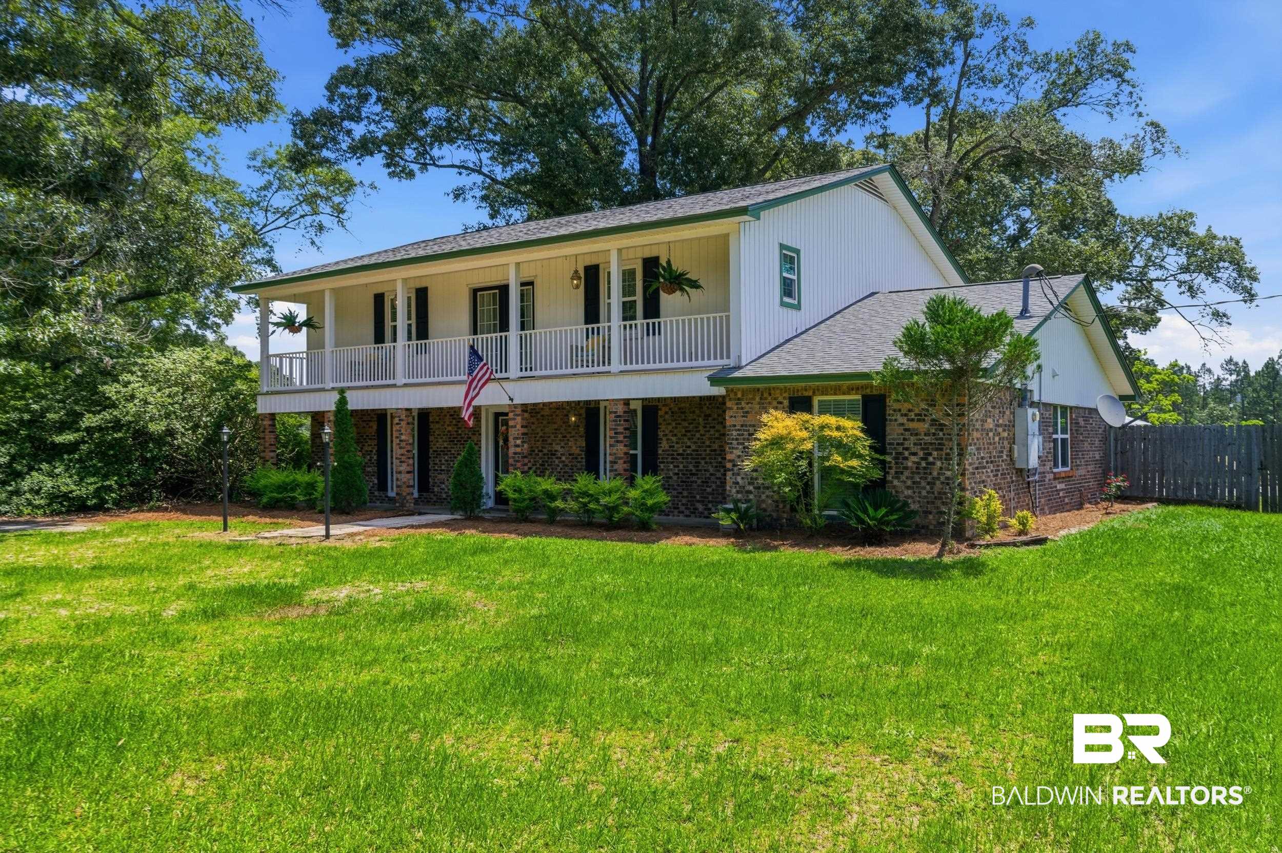 51620 Robert White Road Bay Minette, AL 36507 - Photo 4 of 81 Two-story white siding residence featuring a full-width upper balcony with white railings