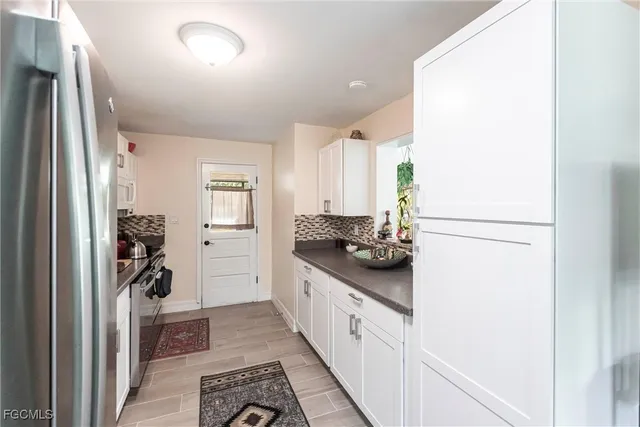 a kitchen with stainless steel appliances granite countertop a refrigerator and a sink