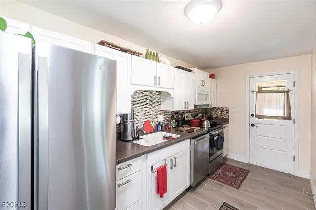 a kitchen with stainless steel appliances a stove and a refrigerator