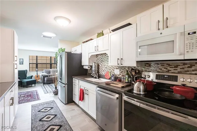 a kitchen with stainless steel appliances granite countertop a stove and cabinets