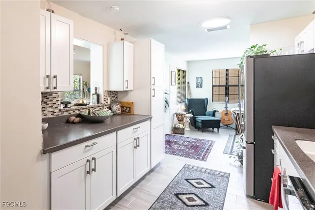 a kitchen with stainless steel appliances sink refrigerator and stove