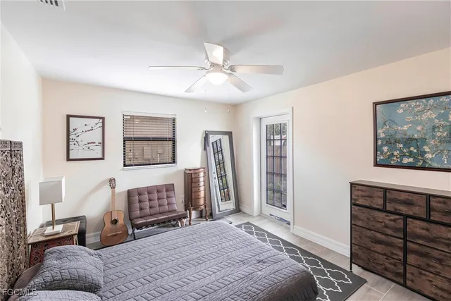 a spacious bedroom with a bed and a dresser