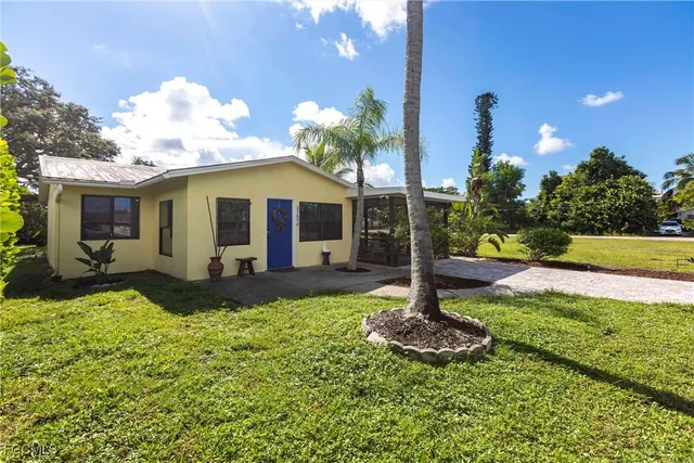 a front view of a house with garden and patio