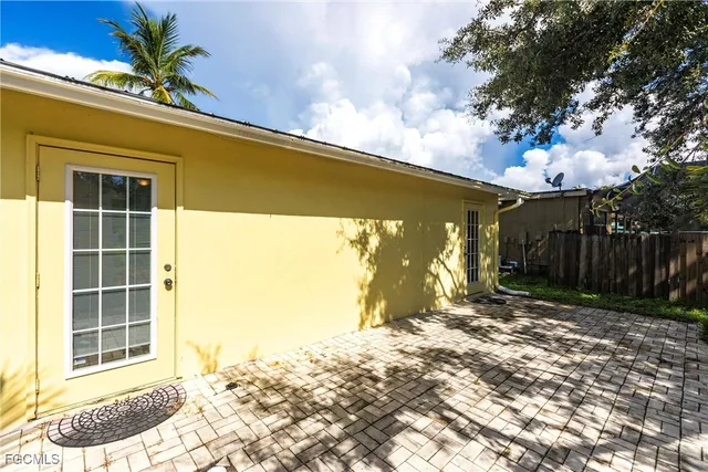 a backyard of a house with table and chairs