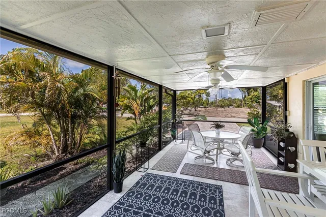 a view of a porch with furniture and a garden
