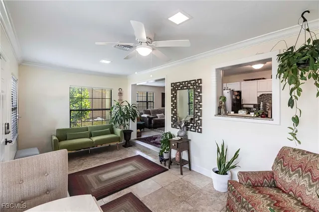 a living room with furniture and a potted plant