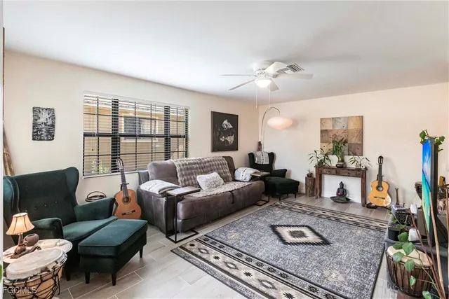 a living room with furniture large window and a table