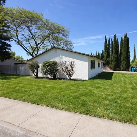 a view of house with yard