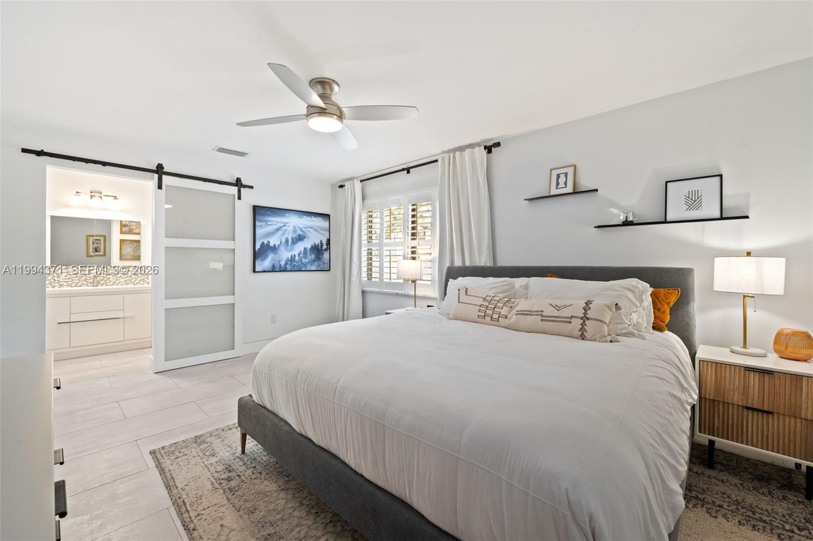 11758 Southwest 92nd Terrace Miami, FL 33186 - Photo 13 of 30 a bedroom with a large bed and a chandelier