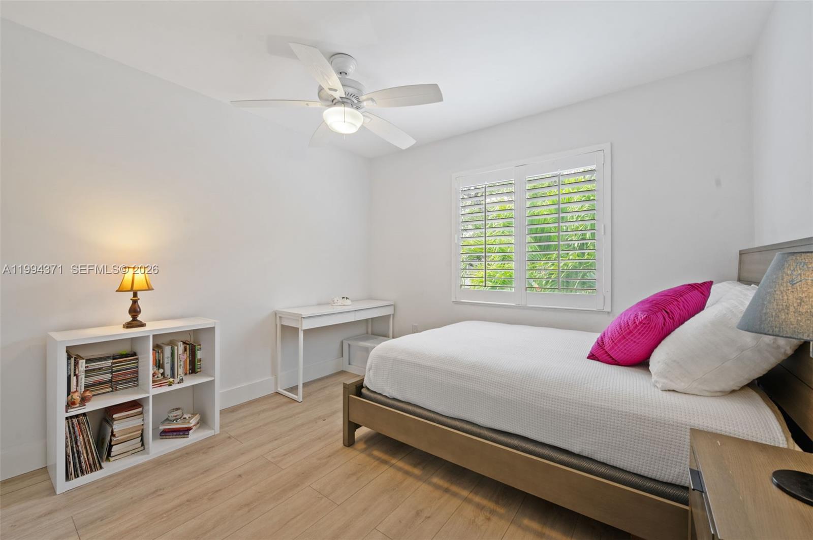 11758 Southwest 92nd Terrace Miami, FL 33186 - Photo 17 of 30 a bedroom with a bed and a chandelier