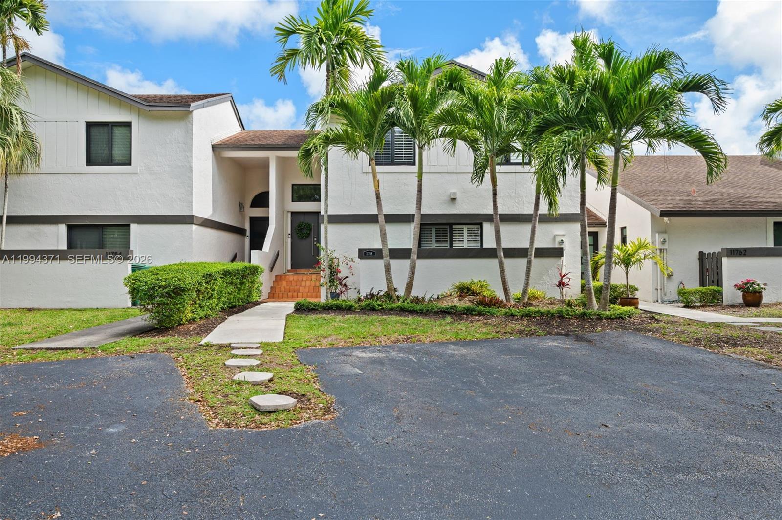 11758 Southwest 92nd Terrace Miami, FL 33186 - Photo 25 of 30 a view of a house with a yard and garage