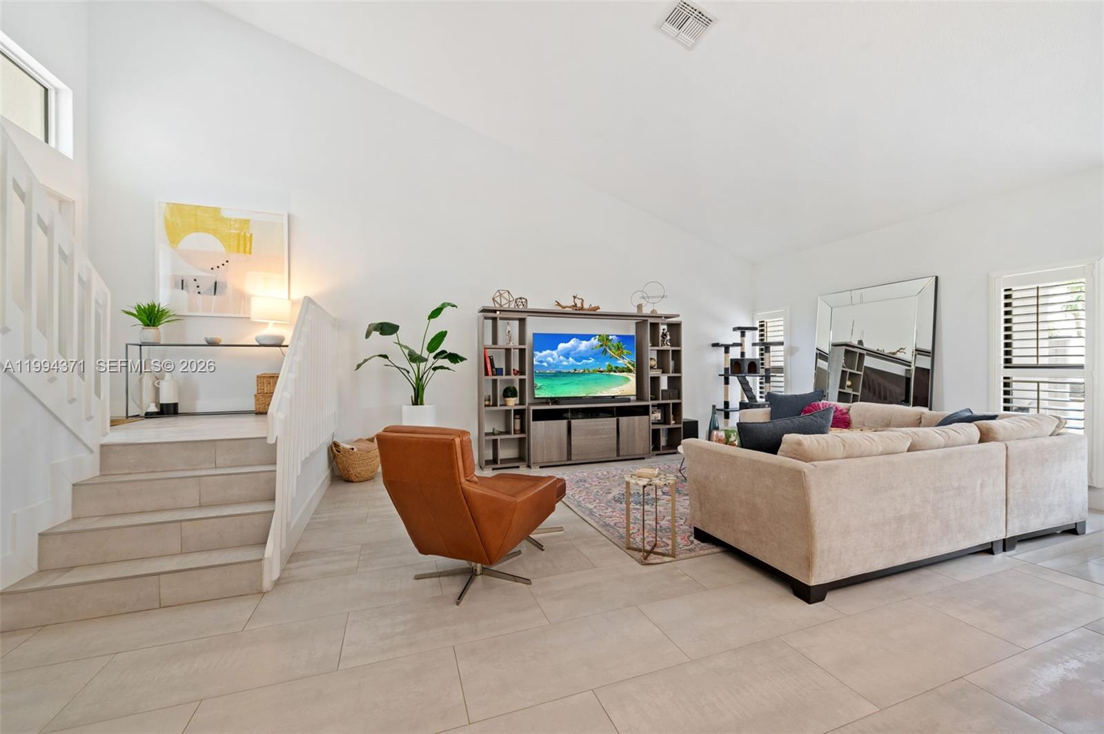 11758 Southwest 92nd Terrace Miami, FL 33186 - Photo 3 of 30 a living room with furniture and a flat screen tv