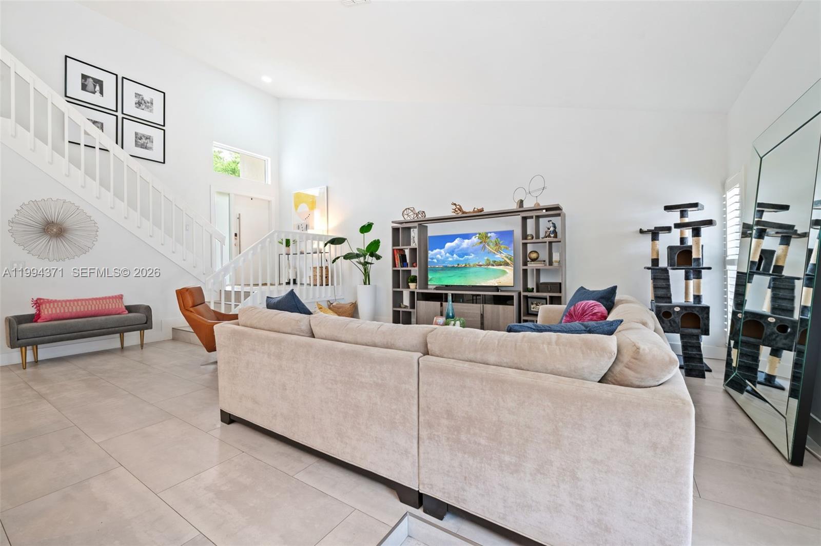 11758 Southwest 92nd Terrace Miami, FL 33186 - Photo 4 of 30 a living room with furniture and a flat screen tv