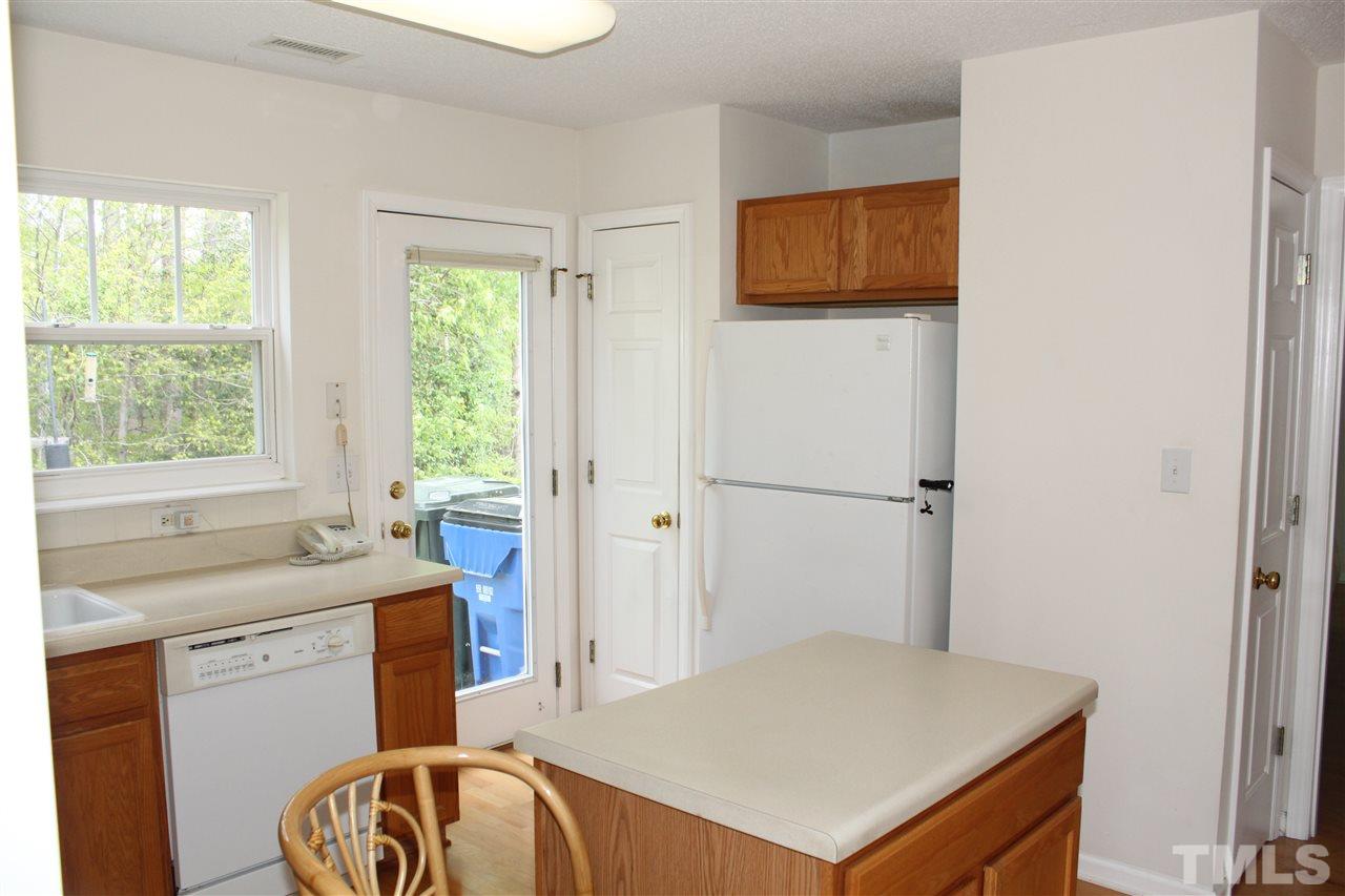 4001 Hopper Street Raleigh, NC 27616 - Photo 14 of 25 a kitchen that has a sink a window and a table in it