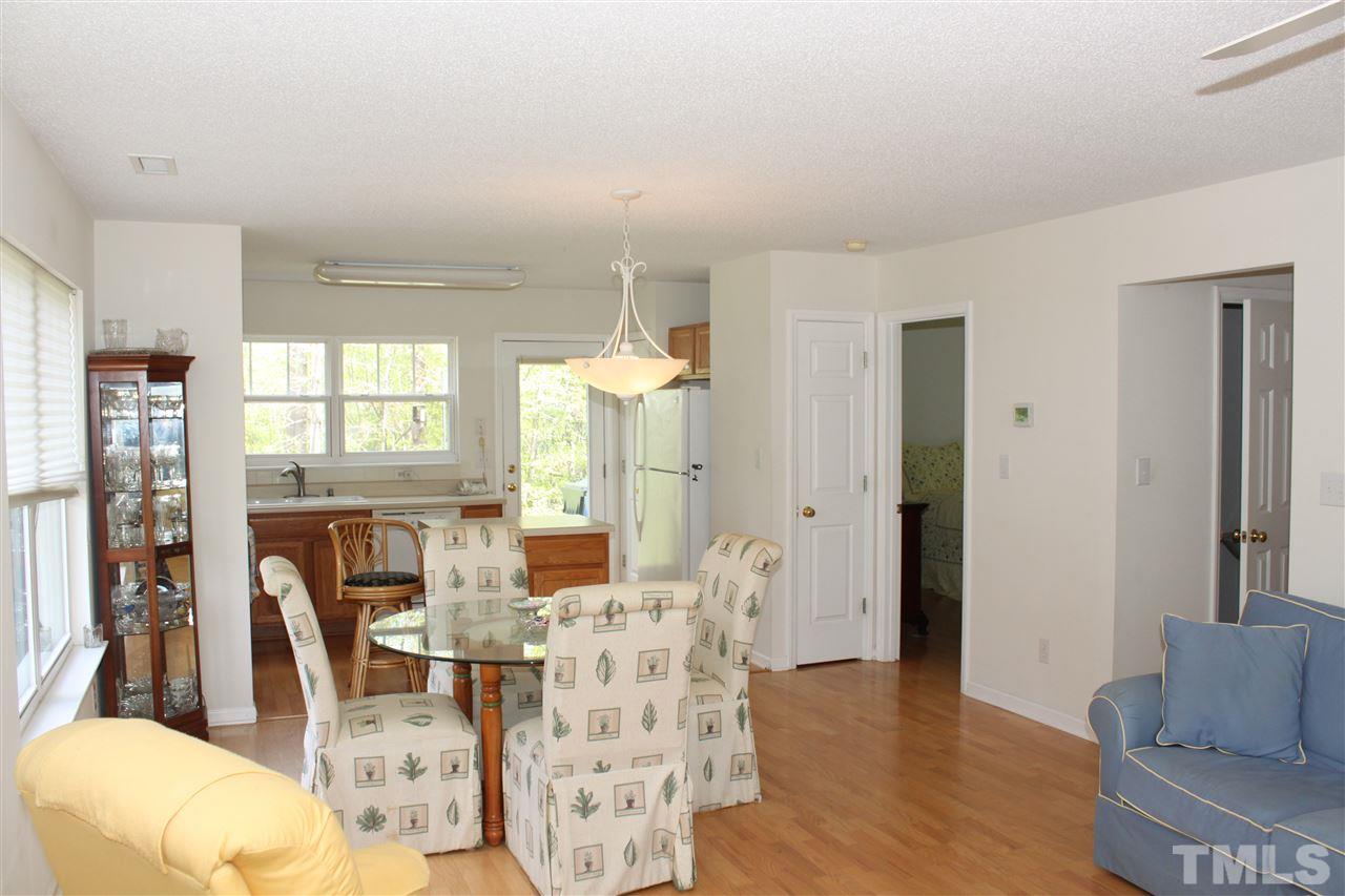 4001 Hopper Street Raleigh, NC 27616 - Photo 8 of 25 a living room with furniture a large window and wooden floor