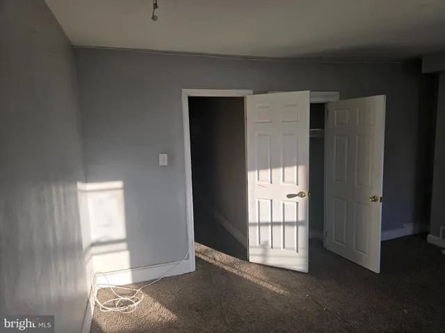 an empty room with a empty space and windows