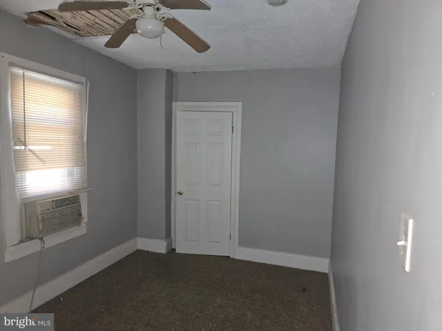 a view of a hallway with wooden shelves