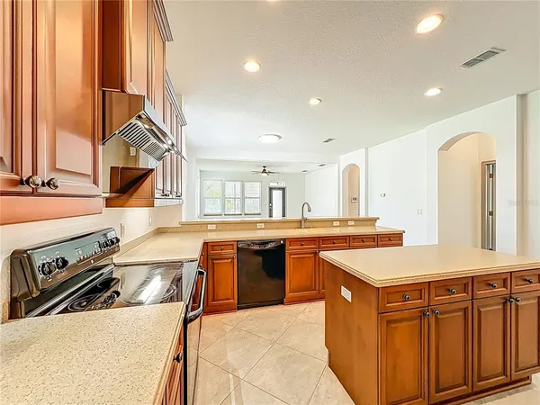 a kitchen with a stove sink and cabinets