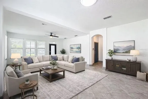 a view of a livingroom with a ceiling fan and window