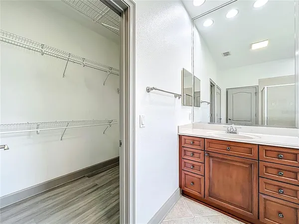 an empty room with a window and a ceiling fan