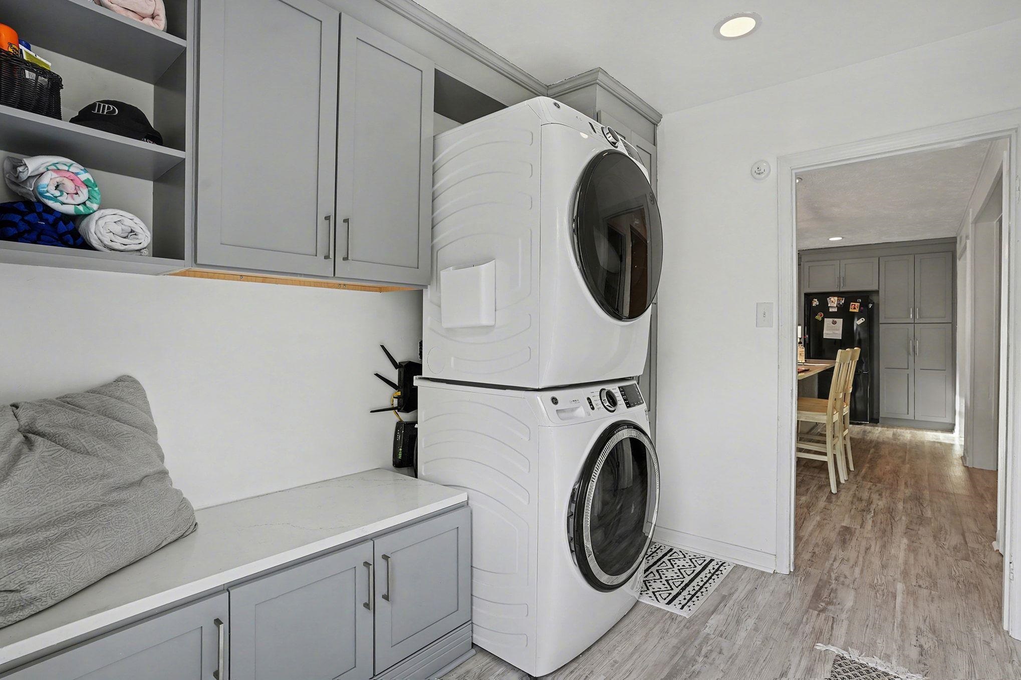 317 Jay Street Murrells Inlet, SC 29576 - Photo 16 of 36 Laundry room featuring cabinet space, stacked washing machine and dryer, light wood finished floors, and recessed lighting