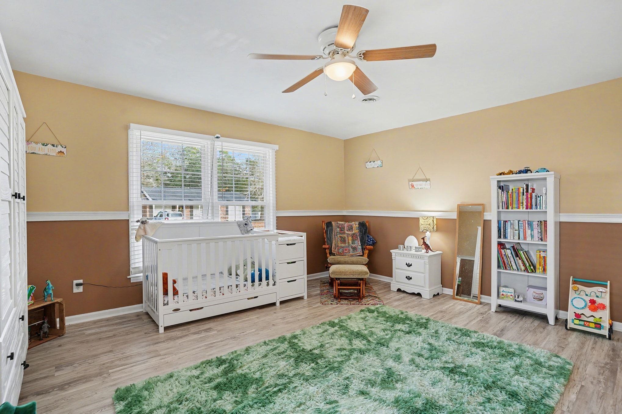317 Jay Street Murrells Inlet, SC 29576 - Photo 22 of 36 Bedroom featuring light wood-style flooring, a nursery area, and ceiling fan