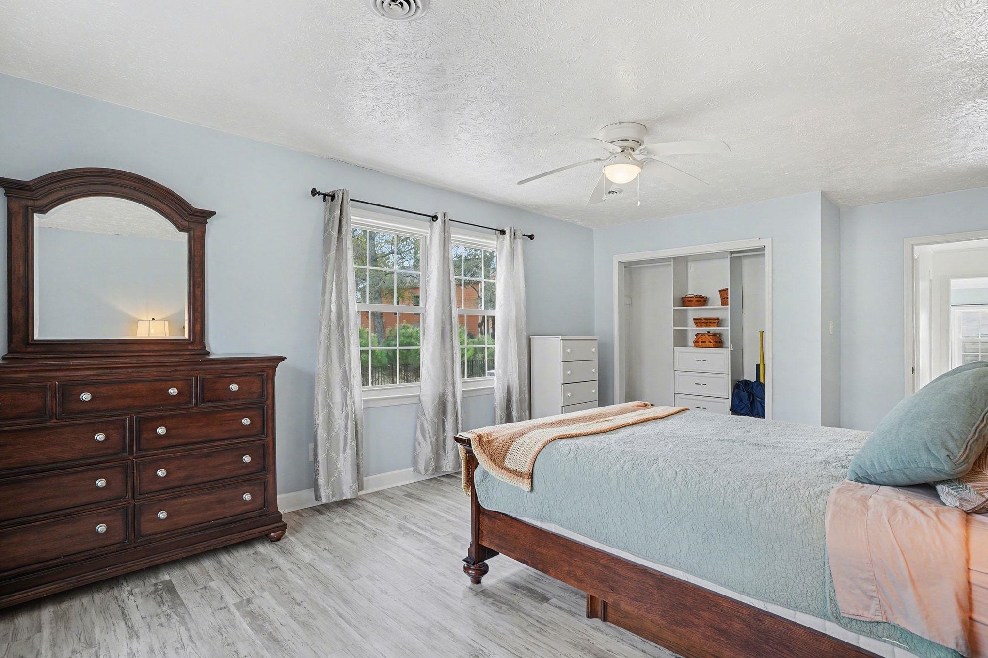 317 Jay Street Murrells Inlet, SC 29576 - Photo 25 of 36 Bedroom with a closet, light wood-type flooring, a ceiling fan, and a textured ceiling