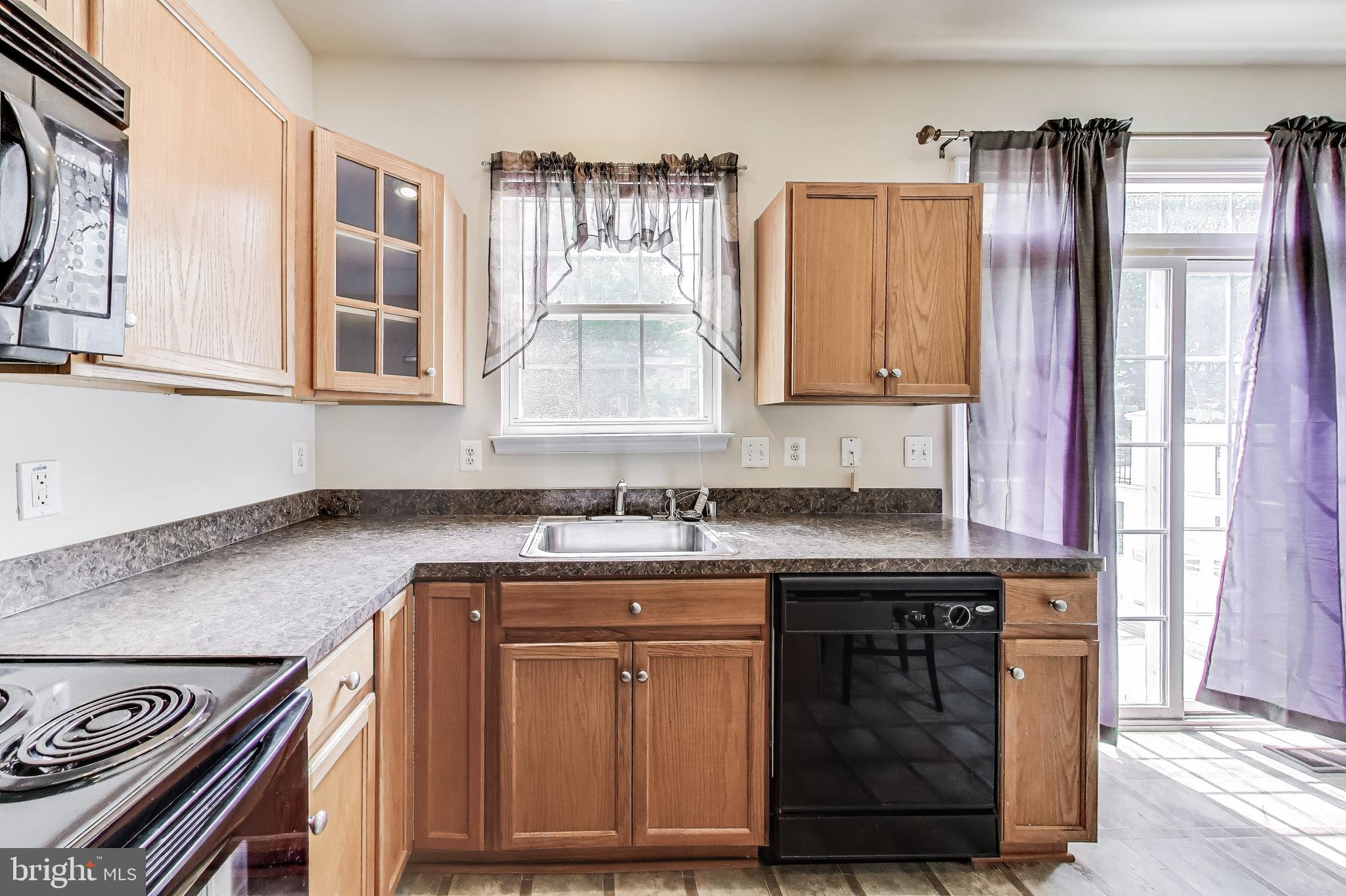 138 Danbury Street Southwest Washington, DC 20032 - Photo 12 of 32 a kitchen with stainless steel appliances granite countertop a stove a sink and a microwave