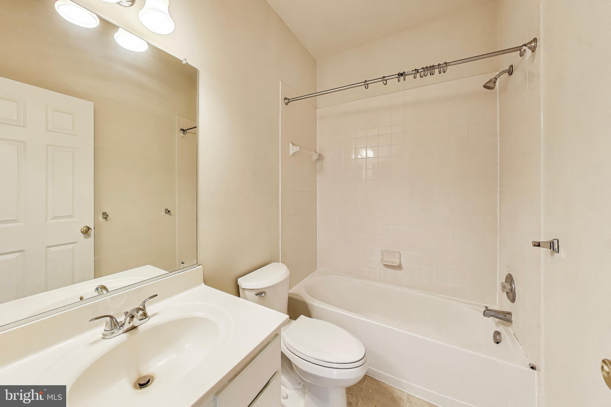 138 Danbury Street Southwest Washington, DC 20032 - Photo 26 of 32 a bathroom with a sink mirror toilet and bathtub