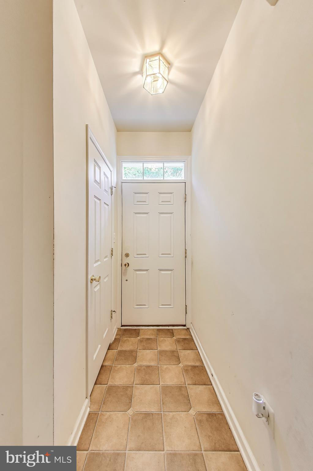 138 Danbury Street Southwest Washington, DC 20032 - Photo 4 of 32 a view of a hallway with a chandelier fan and windows