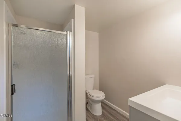a white toilet sitting next to a bathroom sink