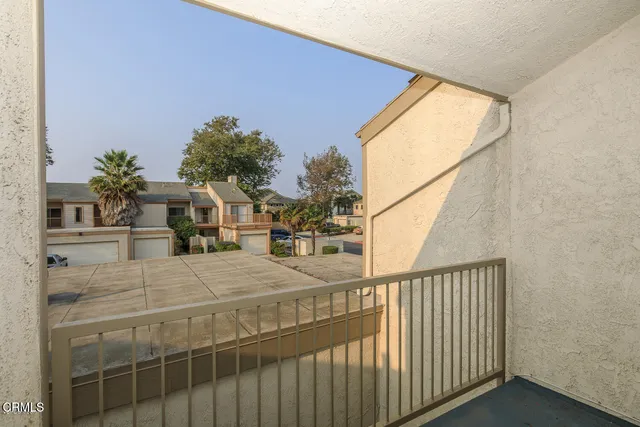 a view of a chair and tables in the balcony