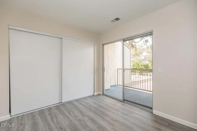 a view of a balcony with yard