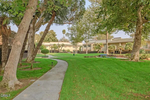 a view of a patio with a table chairs and a backyard