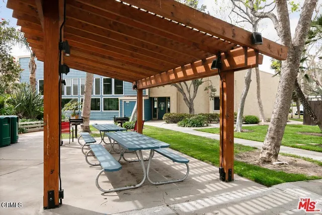 a view of a park with sitting area and garden