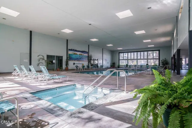 a room with pool table and a large window